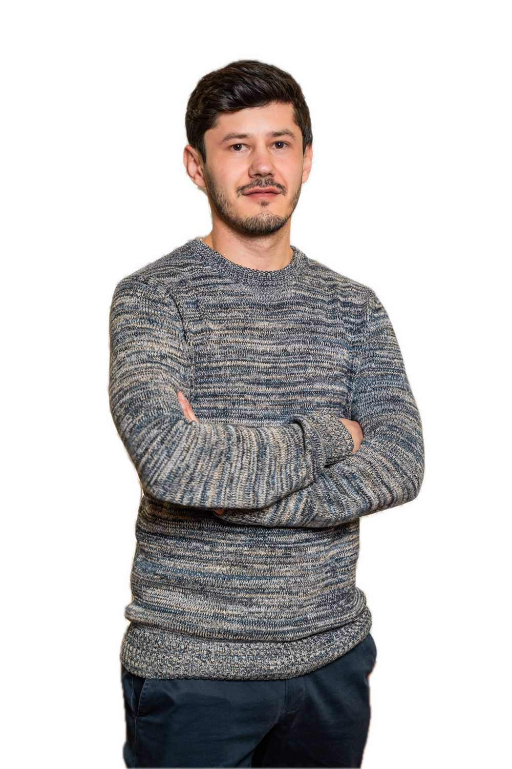 Jack Miro, arms crossed, wearing a grey knit sweater